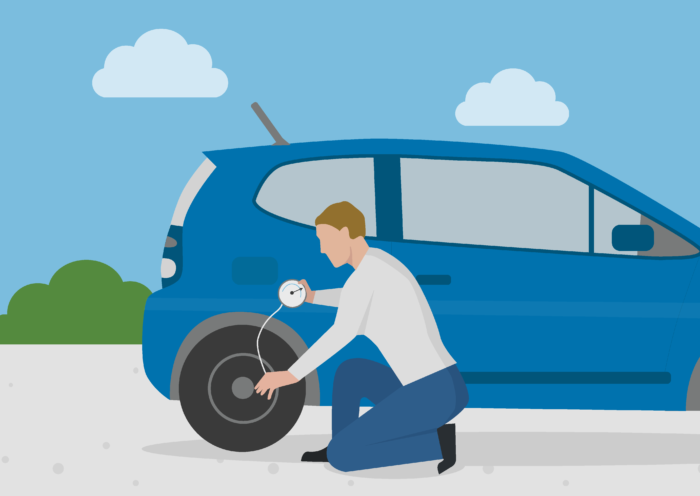 a man checking his tyre pressure to reduce the car’s emissions