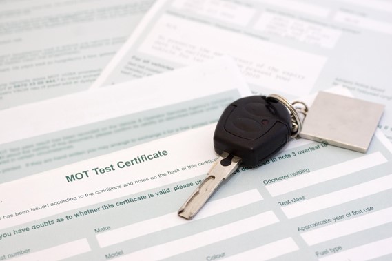 a car key sat on an MOT test certificate